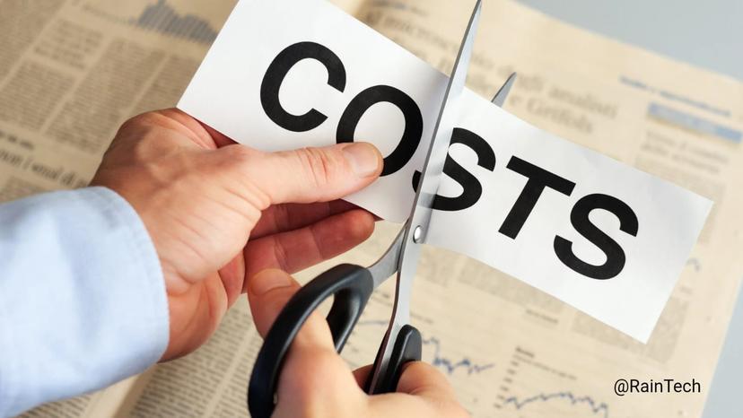 Hand cutting a paper with the word COSTS using scissors, symbolizing cost reduction and savings. 