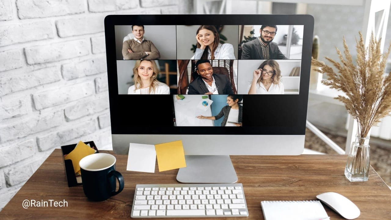 A video conference on a computer screen showing a remote team meeting with seven people.