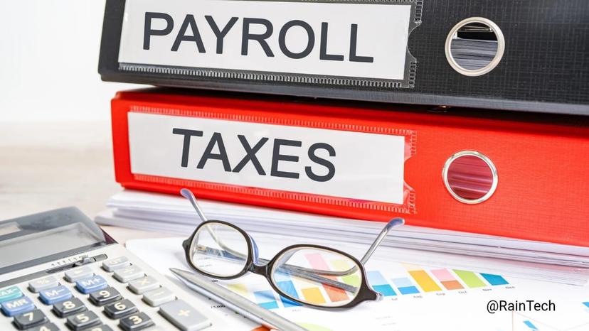 Close-up of payroll and taxes binders stacked on documents with a calculator, eyeglasses, and a financial charts on a desk.