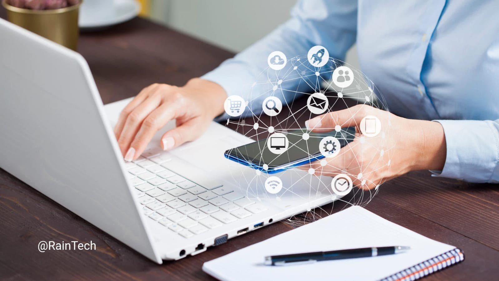 A person using a laptop and smartphone with a digital globe overlay of connected icons, representing global remote work and team connectivity.