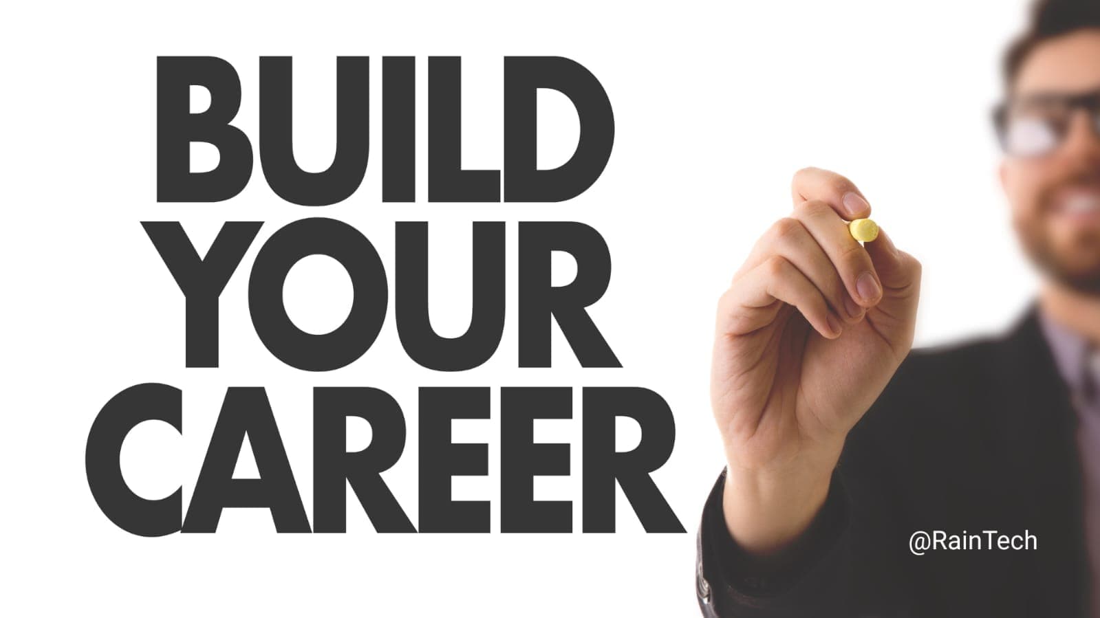 A man drawing the words 'BUILD YOUR CAREER' on a glass board, symbolizing Indonesian graduates starting their global tech journey from university.