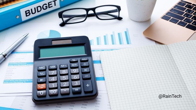 A 2026 tech hiring budget planning session featuring a calculator, financial charts, and a budget folder to maximize engineering runway with an Indonesian remote team.