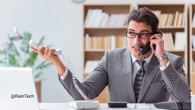 A busy hiring manager multitasking with multiple phones, illustrating the preparation needed before a first call with an Indonesian tech hiring partner or EOR service.